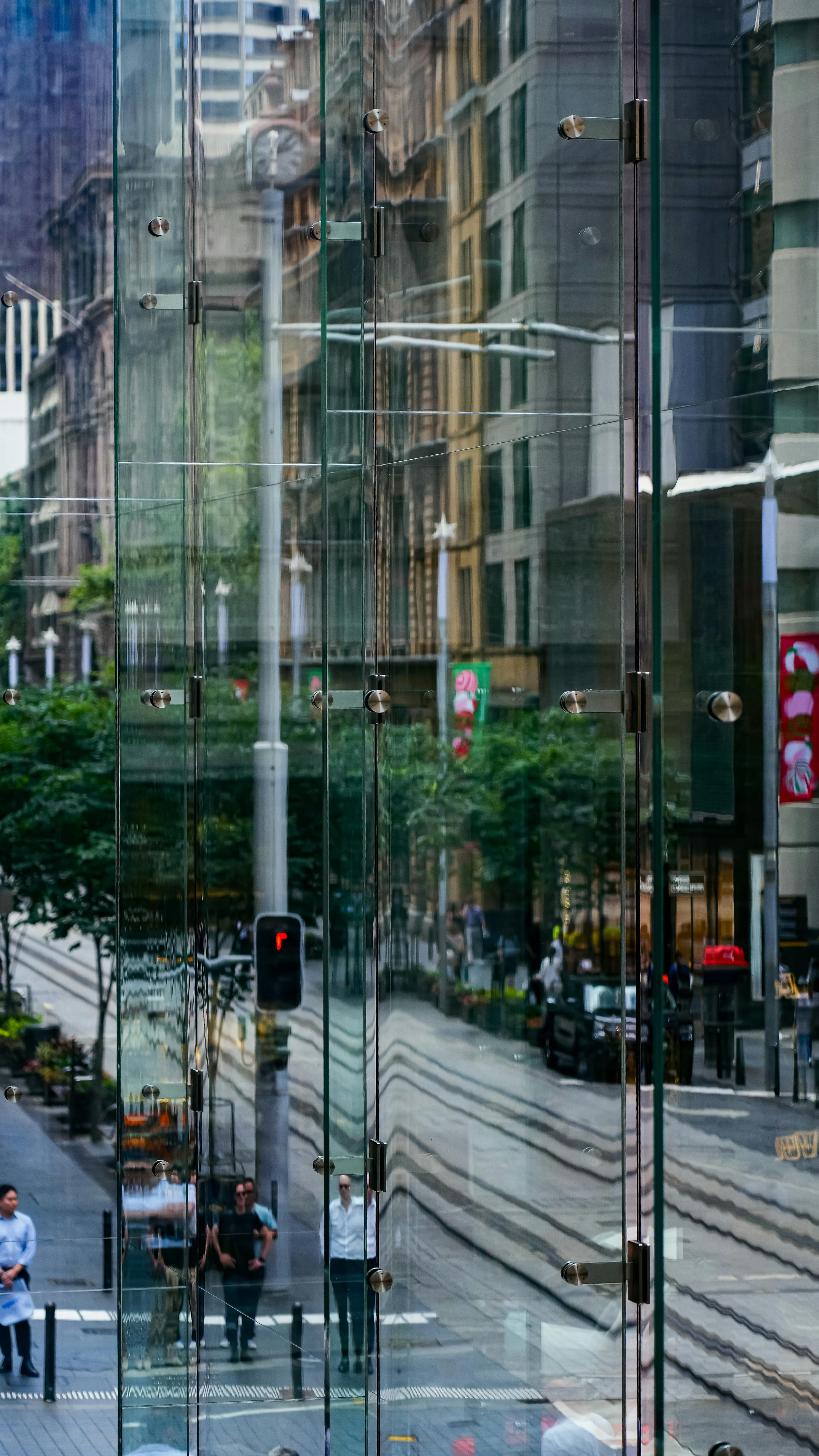 Glass tower facade reflecting the city