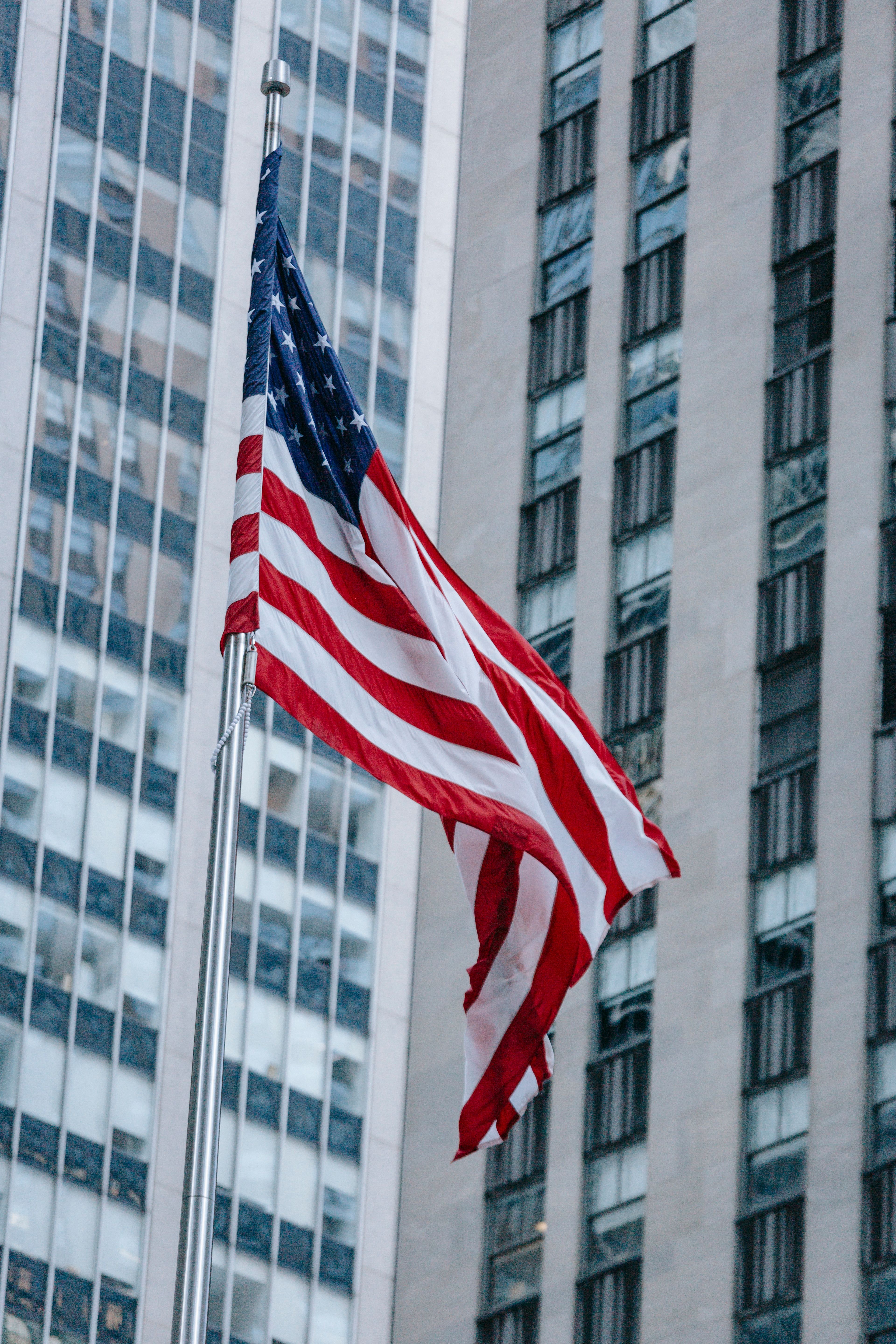A national flag in front of a city skyscraper